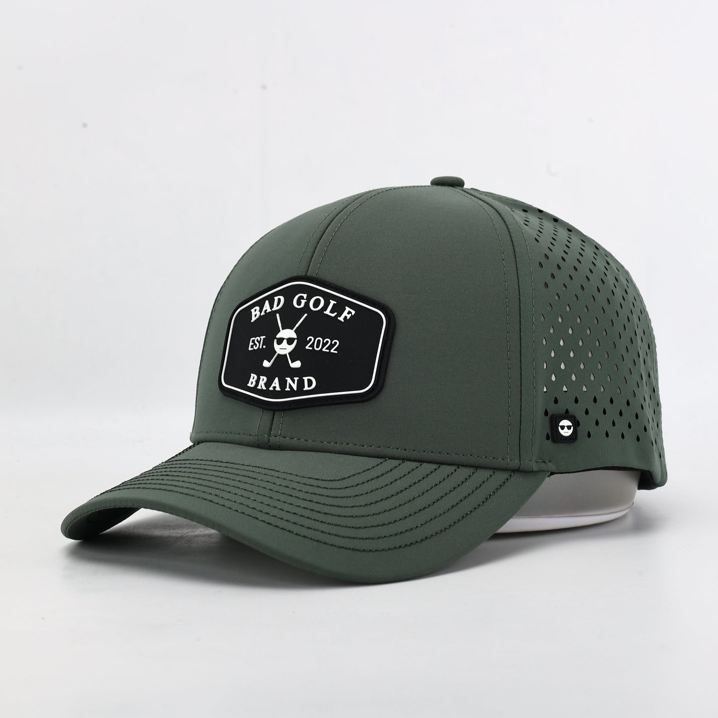 Green baseball cap with a brand logo. The Summit Collection by Bad Golf Brand.