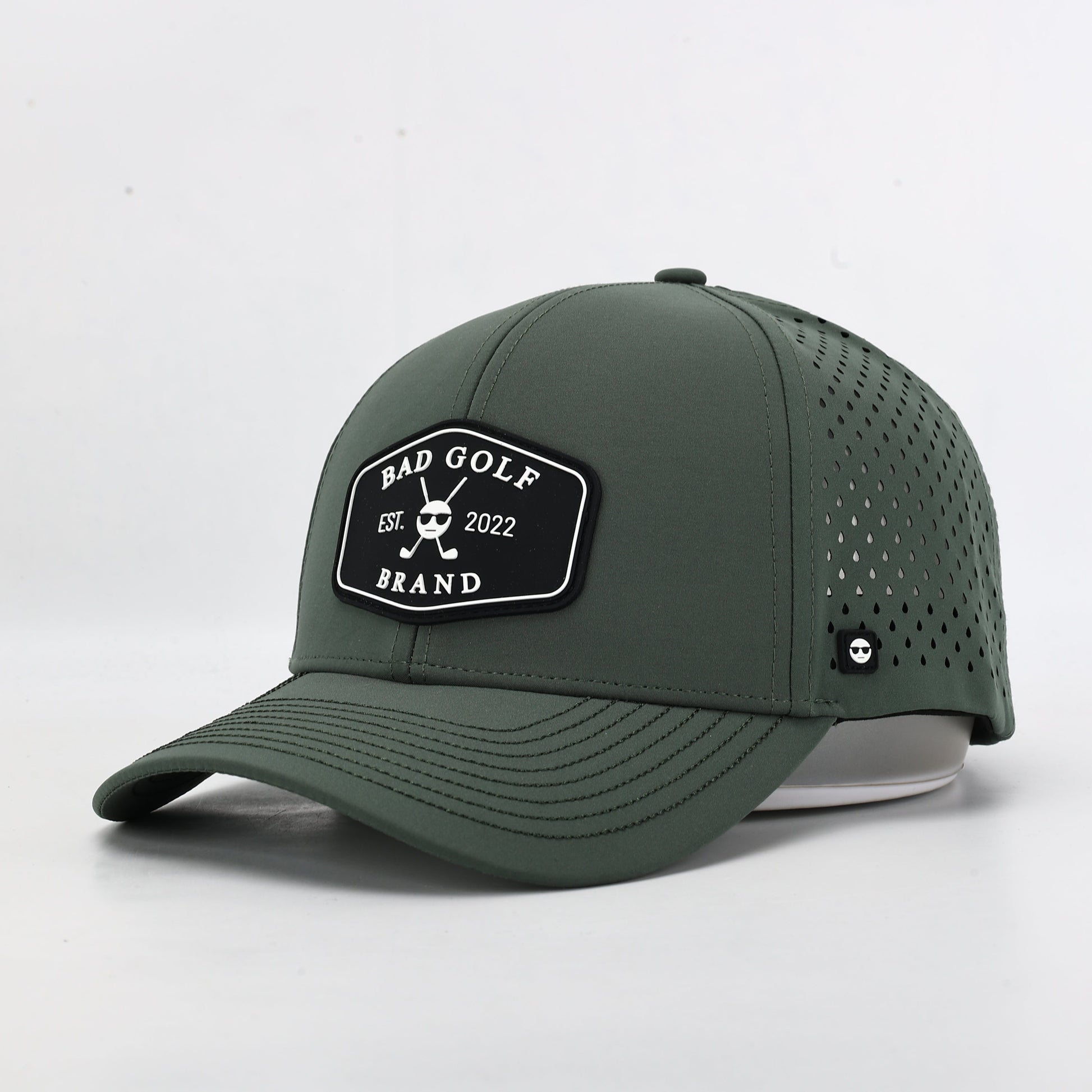 Green baseball cap with a brand logo. The Summit Collection by Bad Golf Brand.