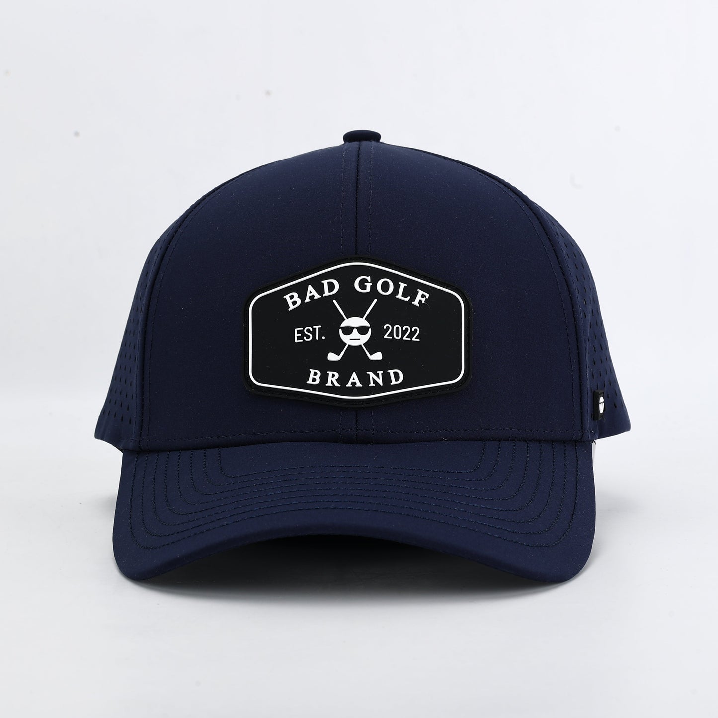 Navy blue cap with a brand logo on a white background. The Summit collection by Bad Golf Brand