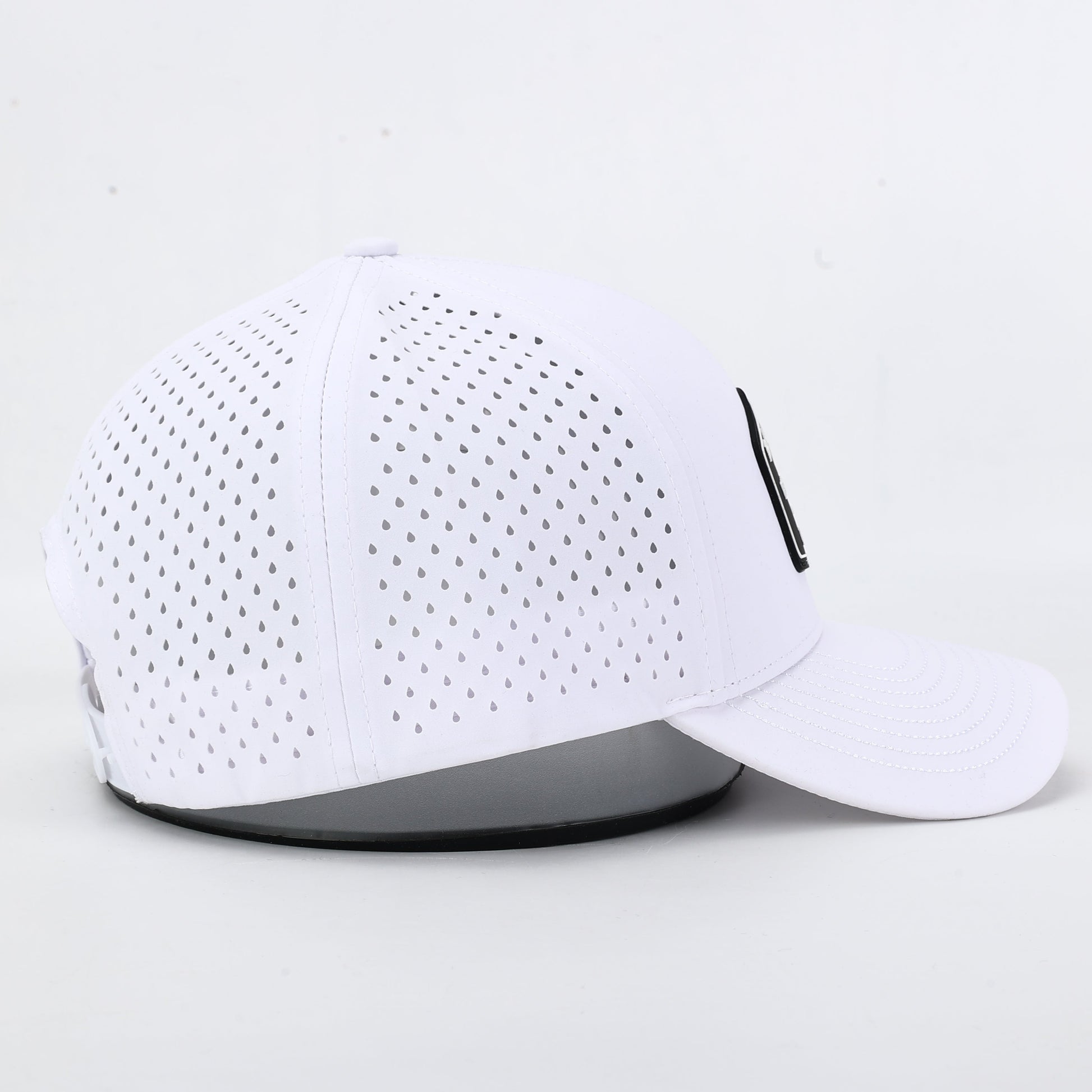 White cap with perforated holes. The summit collection by Bad Golf Brand.